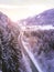 Vertical shot of a trail through snowy pine trees and mountains in Triglav National Park, Slovenia