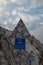 Vertical shot of travelers stickers covering a mountain sign in Biokovo, Croatia