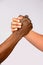 Vertical shot of two people of different races holding hands - concept of equality