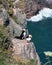 Vertical shot of two puffin birds having rest on the coastline rocks