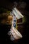 Vertical shot of two small thatched baby carriages hanging from a rope under the lights