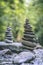 Vertical shot of two stone pyramids balanced on a river water