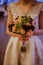 Vertical shot of an unrecognised woman holding a bouquet of flowers and wearing a wedding dres