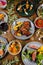 Vertical shot of a variety of dishes on a wooden table decorated with plants