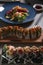 Vertical shot of a variety of sushi dishes on the table of a Japanese restaurant