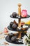 Vertical shot of various types of cakes and biscuits on a cake stand