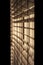 Vertical shot of venetian blinds creating a moody and noir inspired atmosphere