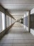 Vertical shot of a very long empty hallway with bicycle tires sticking out on one side