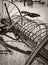 Vertical shot of a vintage hay rake lying in a farm field