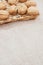 Vertical shot of walnuts on wicker basket on a burlap pouch