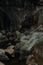 Vertical shot of water in the middle of rocks at Ba Ho Waterfalls Cliff in Vietnam