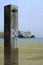 Vertical shot of a water shower at the beach with a \'no shower\' sign