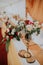 Vertical shot of wedding table decorations with beautiful floral compositions