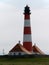 Vertical shot of Westerhever lighthouse in North Frisian Wadden Sea Pellworm Germany