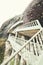 Vertical shot of white antique stairs going up by the cliff