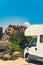 Vertical shot of a white camper van standing near the famous Meteora monasteries. House on wheels concept. Blue sky.