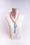 Vertical shot of a white upper body mannequin with a colorful necklace on it
