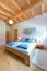 Vertical shot of wooden bed in bedroom