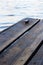 Vertical shot of wooden boats above the water