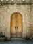 Vertical shot of a wooden door into an old building - perfect for background