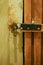 Vertical shot of a wooden locked basement door in a dark corridor