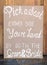 Vertical shot of a wooden pick a seat wedding sign