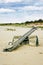 Vertical shot of a wooden teeter totter in the beach