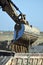 Vertical shot of a working bulldozer under a blue sky