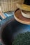 Vertical shot of woven baskets, broom and dried tea leaves in a bowl