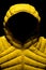 Vertical shot of a yellow down jacket on black background