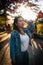 Vertical shot of a young cute Filipino woman posing outdoor in a park