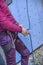 Vertical shot of a young female athlete getting ready to climb a wall