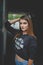 Vertical shot of a young female model in casual clothing posing in a tunnel