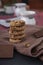 Vertical shot of yummy cookies and a bar of chocolate on a brown towel