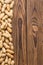 Vertical side border of whole peanuts on wood