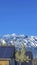 Vertical Solar panels installed on the roof of home against snowy mountain and blue sky