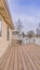 Vertical Spacious balcony of a home with wooden floor and white railing