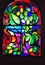 Vertical stained glass window with abstract background of multicolored glass with plant and fruit ornaments