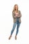 Vertical studio isolated copy space shot of a young blond caucasian semi-formally dressed woman with crossed arms