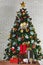 Vertical studio shot of colorful small and big present gift boxes with shiny ribbon bow tie placed on wooden table in front fully