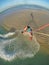 VERTICAL: Stunning view from the kite of a kiteboarder jumping high in the air.