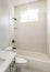 Vertical Sun flare Bathroom with window, white interior, and black fixtures