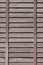 Vertical texture of a wall from several rows of brown old wooden boards. Painted wooden wall in brown colo