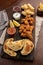Vertical top view of a picada board with nuggets and tequenos with lemon slices and spicy sauces