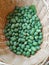 Vertical top view shot of a basket full of miniature watermelons