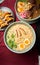 Vertical top view of steaming hot Japanese dishes ready to serve