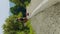 Vertical tourist walks along a hot highway under the scorching rays of the sun