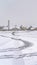 Vertical Tracks on snowy road amid homes in Daybreak Utah