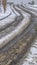 Vertical Tracks on a snowy road in Daybreak during winter