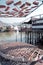 Vertical traditional Hong Kong old wooden house, sun dried fish, boat and river in countryside